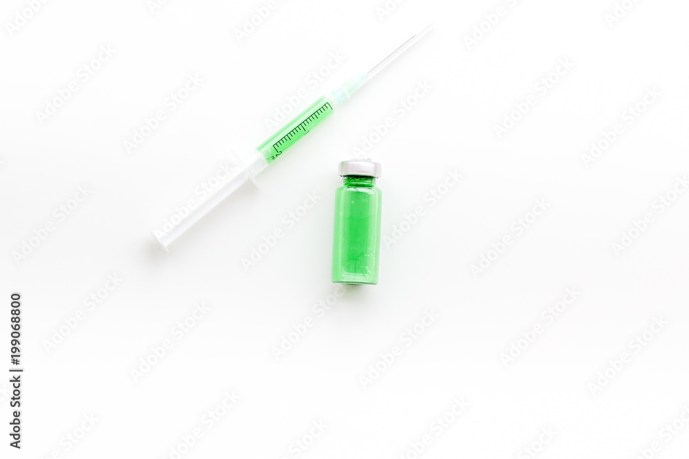 Syringe with colored drug. Injection concept on white background top view copy space Syringe with colored drug. Injection concept on white background top view copy space