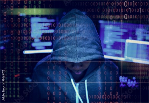 Hacker in a hoody with tech background
