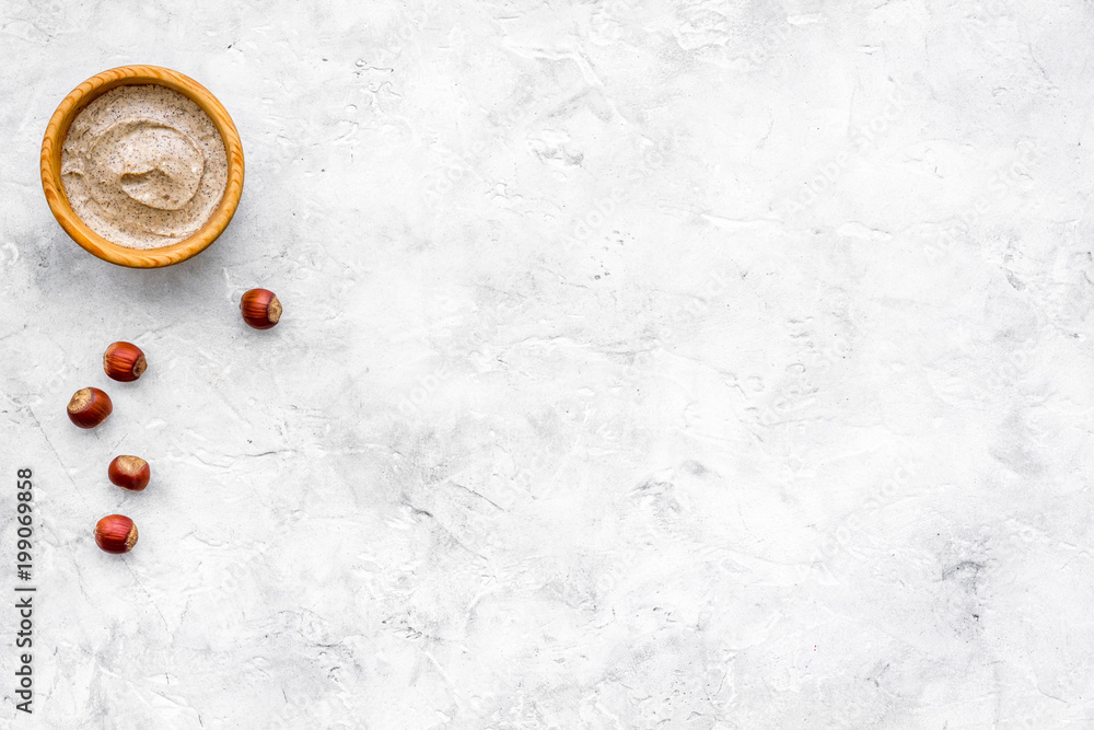 Homemade spa with organic scrub and hazelnut on stone background top view space for text Homemade spa with organic scrub and hazelnut on stone background top view space for text
