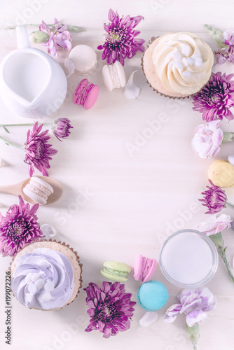 macarons or macaroons and cupcakes with milk on a vintage pastel color dessert sweet beautiful to eat
