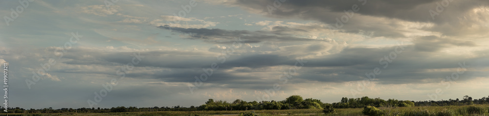 Fototapeta premium vibrant cloudscape over the wetlands panorama