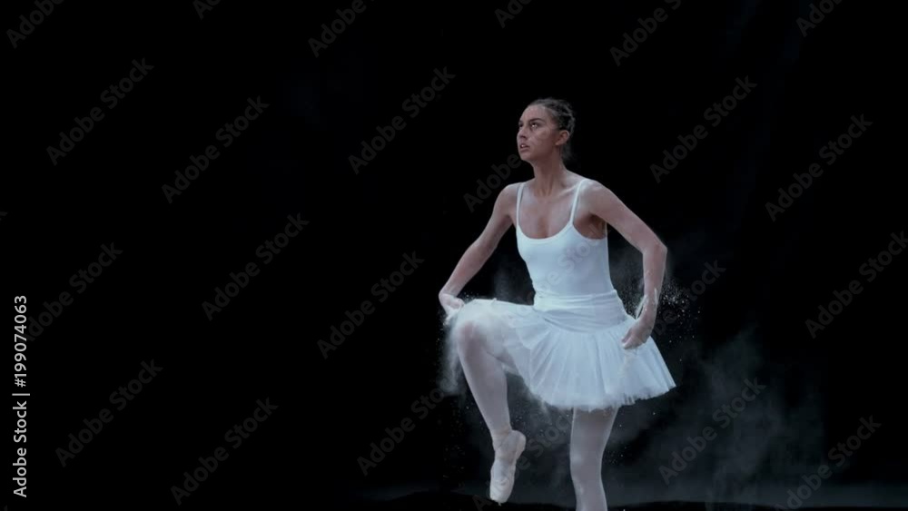 Ballerina performing on black background spinning slow motion Ballerina performing on black background spinning slow motion