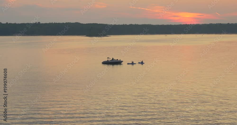 Two canoes and a boat at sunset Two canoes and a boat at sunset
