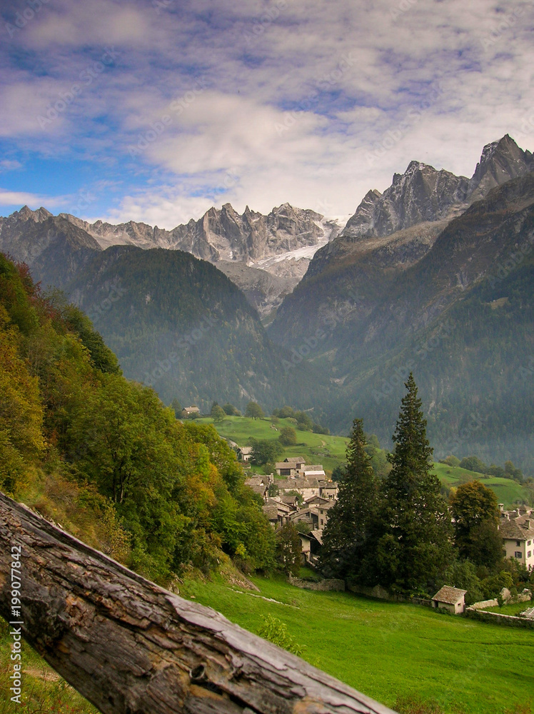 idyllic and picturesque mountain village in the Alps of Switzerland with a great mountain landscape view behind