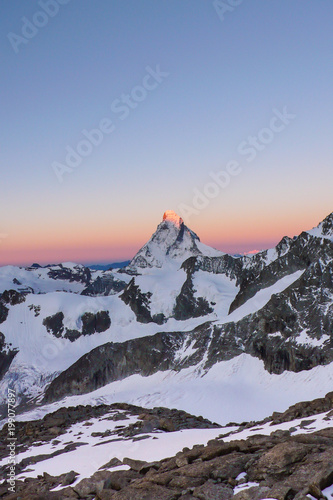 dawn and a new day begin over the famous Matterhorn peak in Switzerland