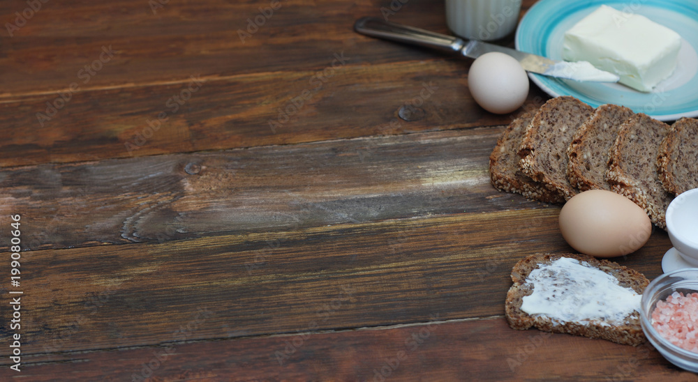 Fitness Healthy Breakfast. rustic Food on Wooden background with copy Space. Eggs, Whole Grain Bread, Butter, Knife, Blue Plate. Banner.