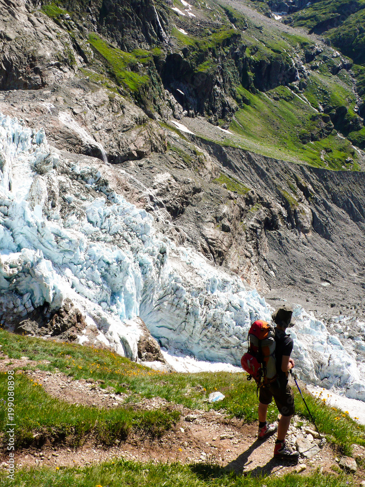 male hiker looking at a receding glacier near Grindelwald in the Swiss Alps