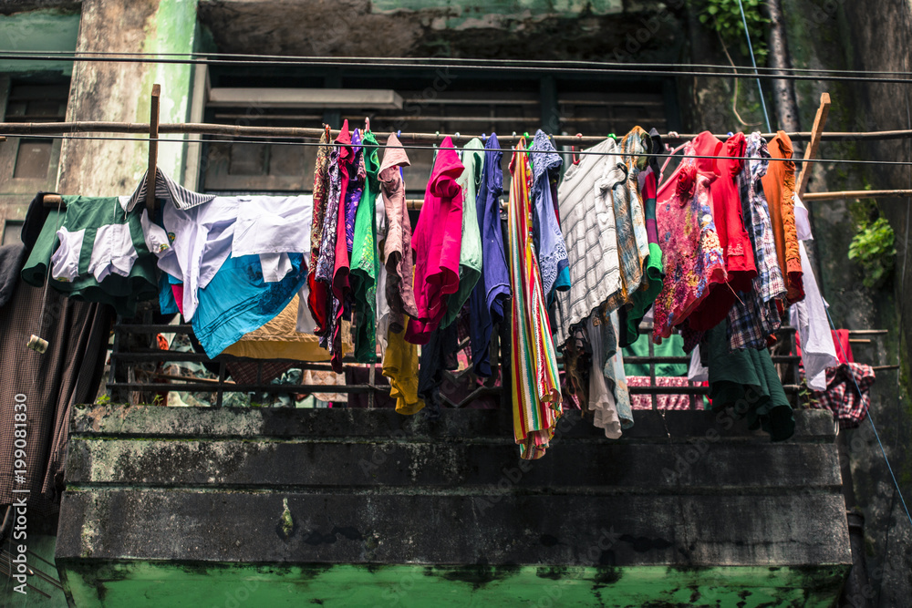 Laundry hanging outside of Old colonial window wooden architecture in Yangon Myanmar Burma South East Asia.