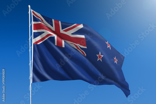 New Zealand flag in front of a clear blue sky © Derek Brumby