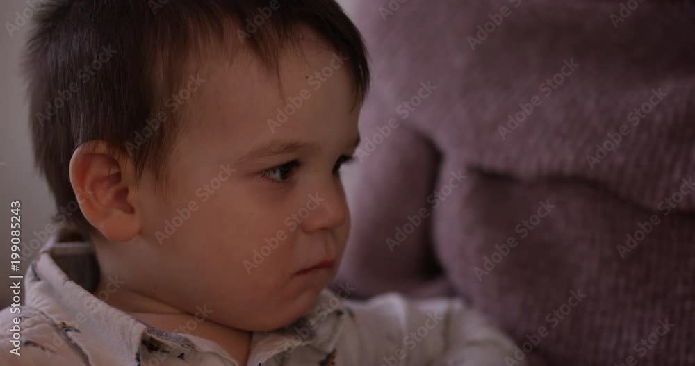 Toddler boy bites lip out of fear while watching tv
