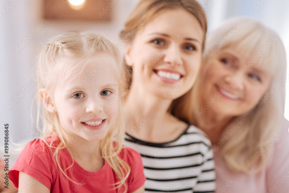 So cute. Pleasant nice pretty girl smiling and looking at you while being together with her family So cute. Pleasant nice pretty girl smiling and looking at you while being together with her family