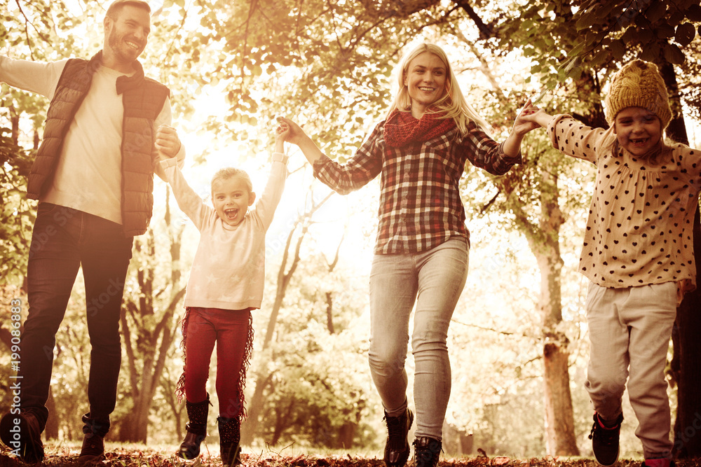 Fototapeta premium Smiling family in park. Close up.