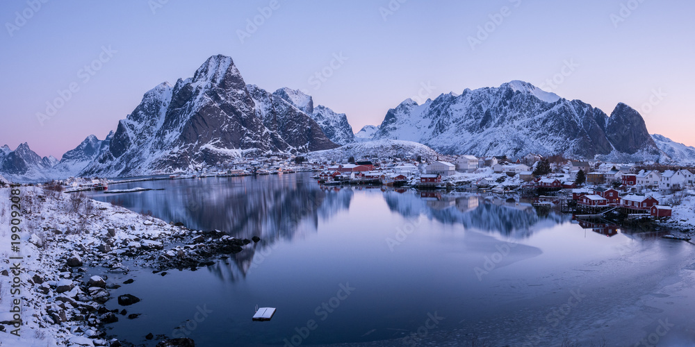 late evening wiew with reflecion in the water and mountains in background, reine, lofoten, norway