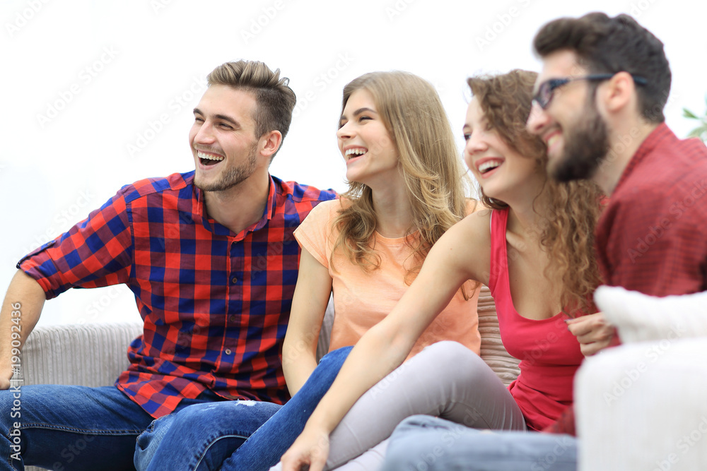 group of cheerful friends sitting on the couch group of cheerful friends sitting on the couch