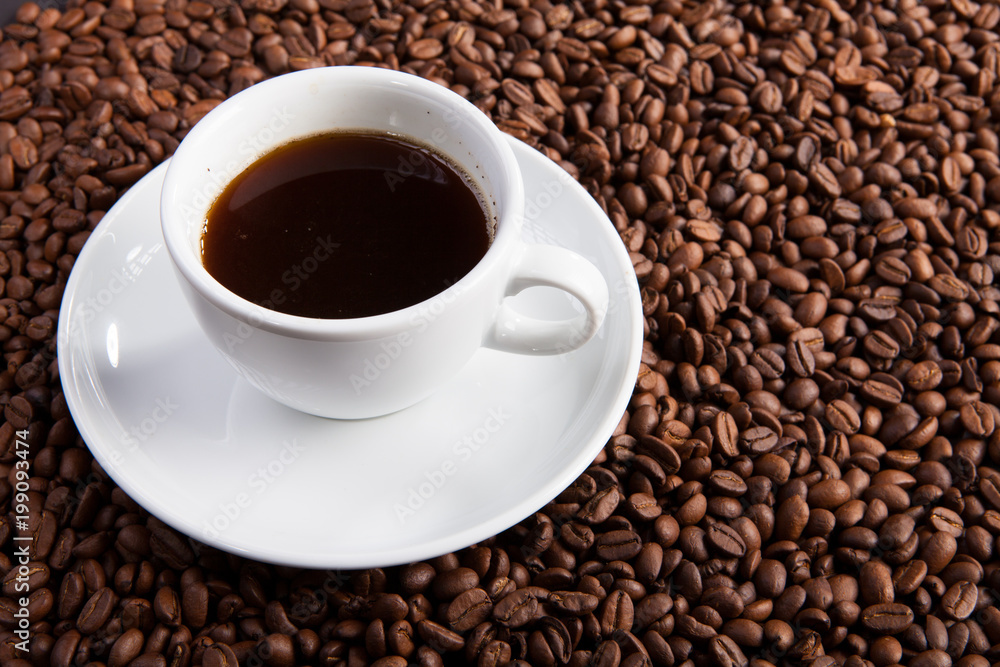 white cup of coffee at coffee beans backgrounds white cup of coffee at coffee beans backgrounds