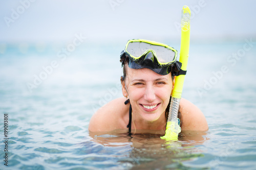 Portrait of young woman with mask and snorkel in sea