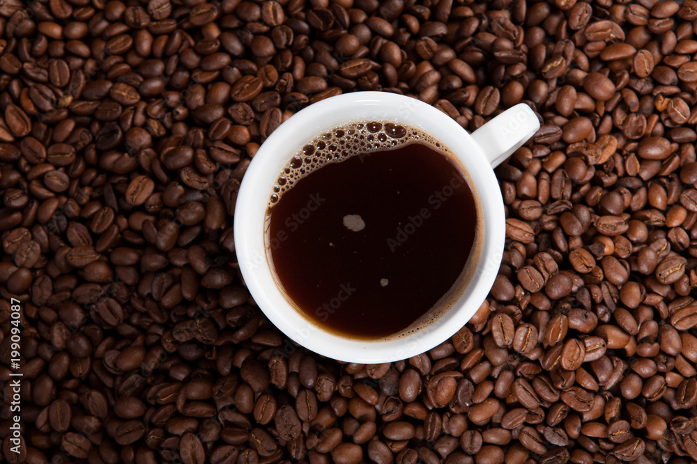 white cup of coffee at coffee beans backgrounds white cup of coffee at coffee beans backgrounds