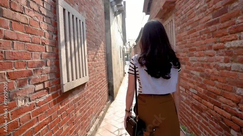 back view of the Asian woman walking photo