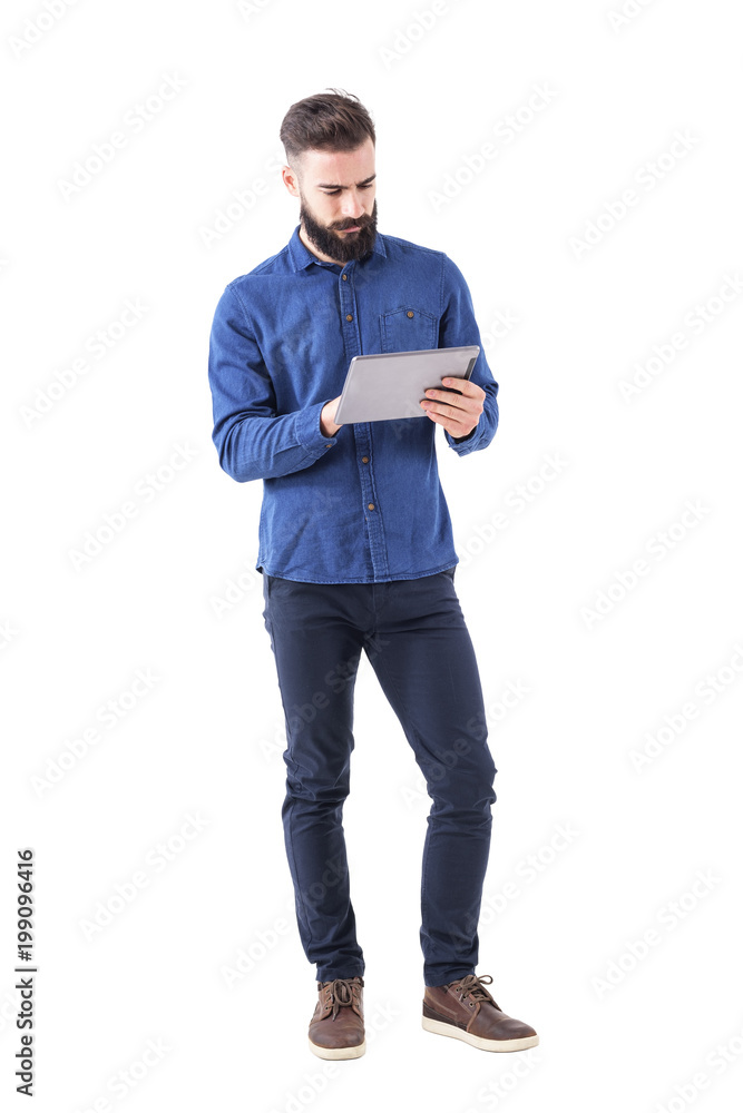 Confident serious bearded business man using tablet touch pad screen ...