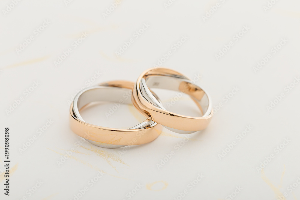 Silver and gold wedding rings on white background Silver and gold wedding rings on white background