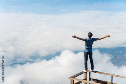 Young man dare to standing on the wooden terraces.
