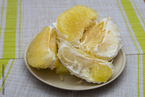 Purified pomelo lying in a plate photo