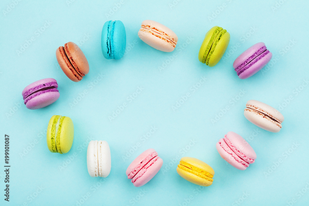 Frame from cake macaron or macaroon on mint pastel background from above. Colorful cookies on dessert top view. Frame from cake macaron or macaroon on mint pastel background from above. Colorful cookies on dessert top view.