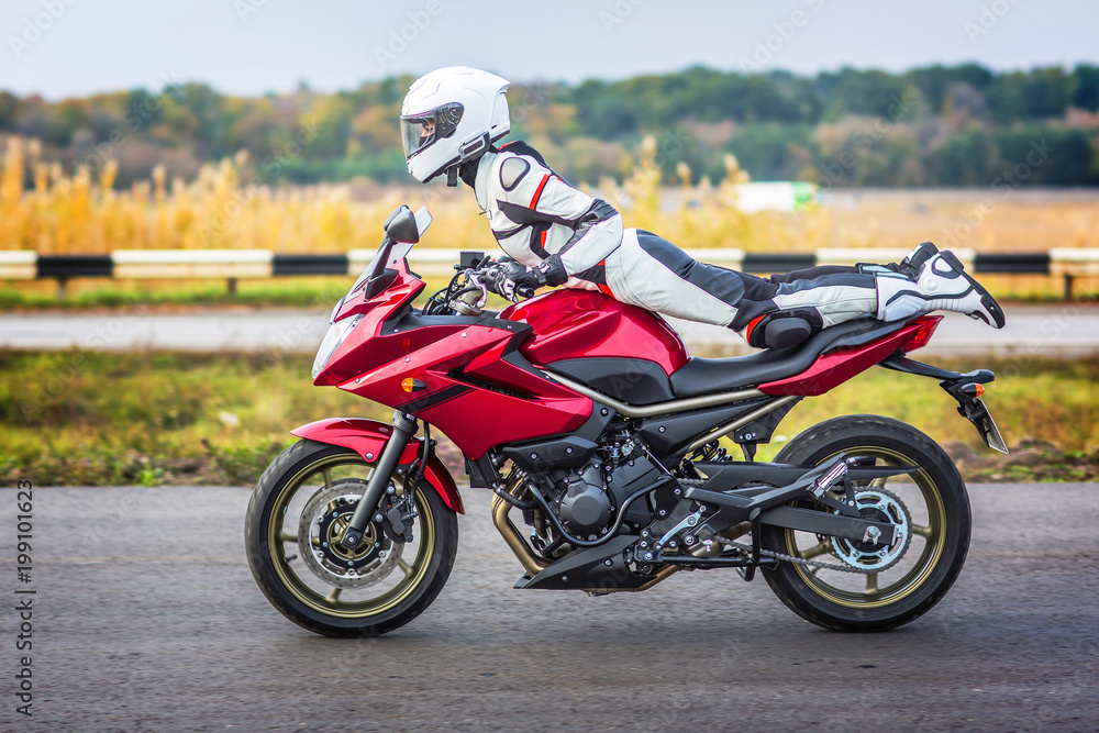 Young girl with a sports motorcycle.