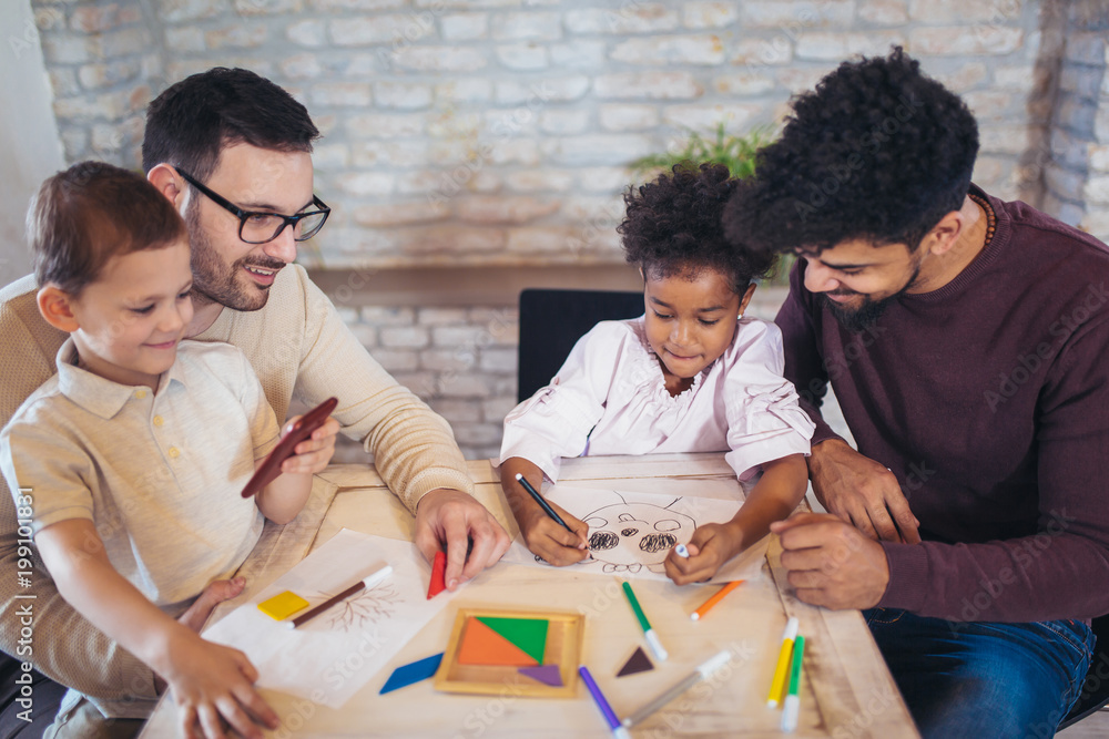 Two fathers play educational games with their children, having fun. Two fathers play educational games with their children, having fun.