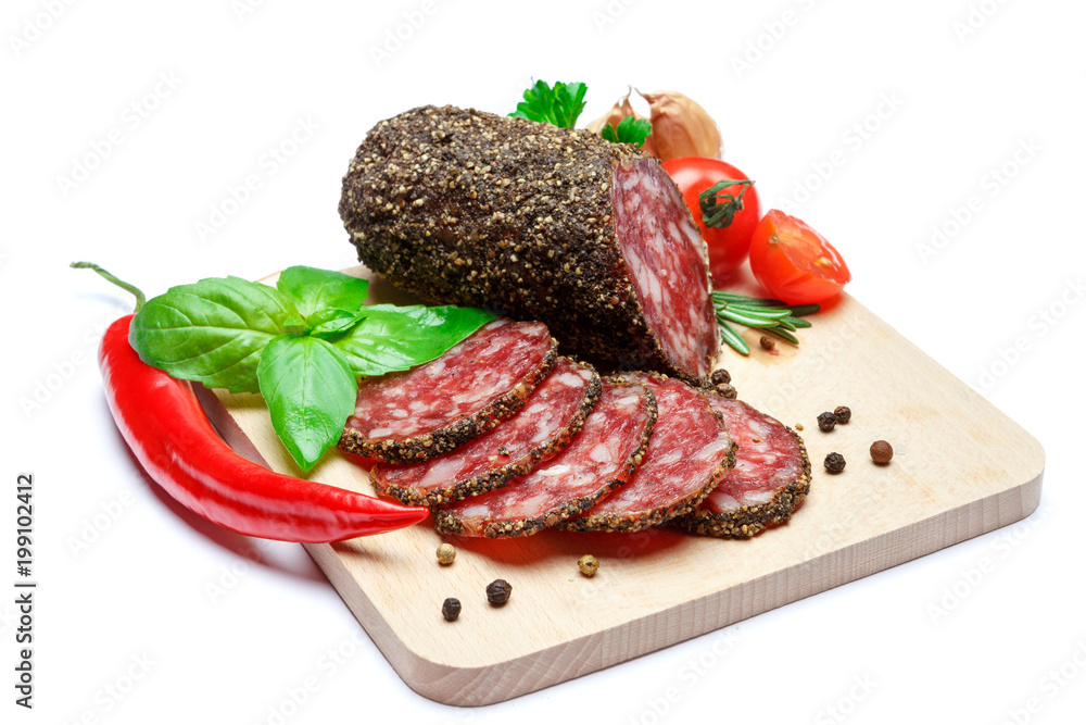 Dried organic salami sausage covered with pepper on wooden serving board Dried organic salami sausage covered with pepper on wooden serving board
