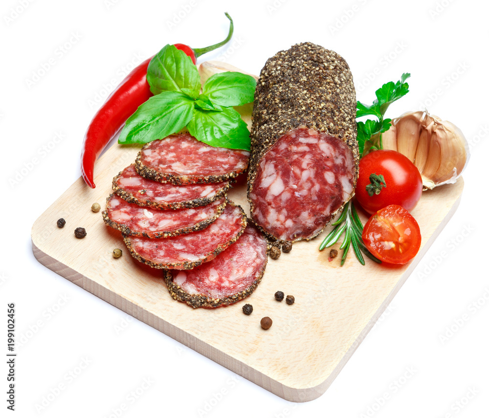 Dried organic salami sausage covered with pepper on wooden serving board Dried organic salami sausage covered with pepper on wooden serving board