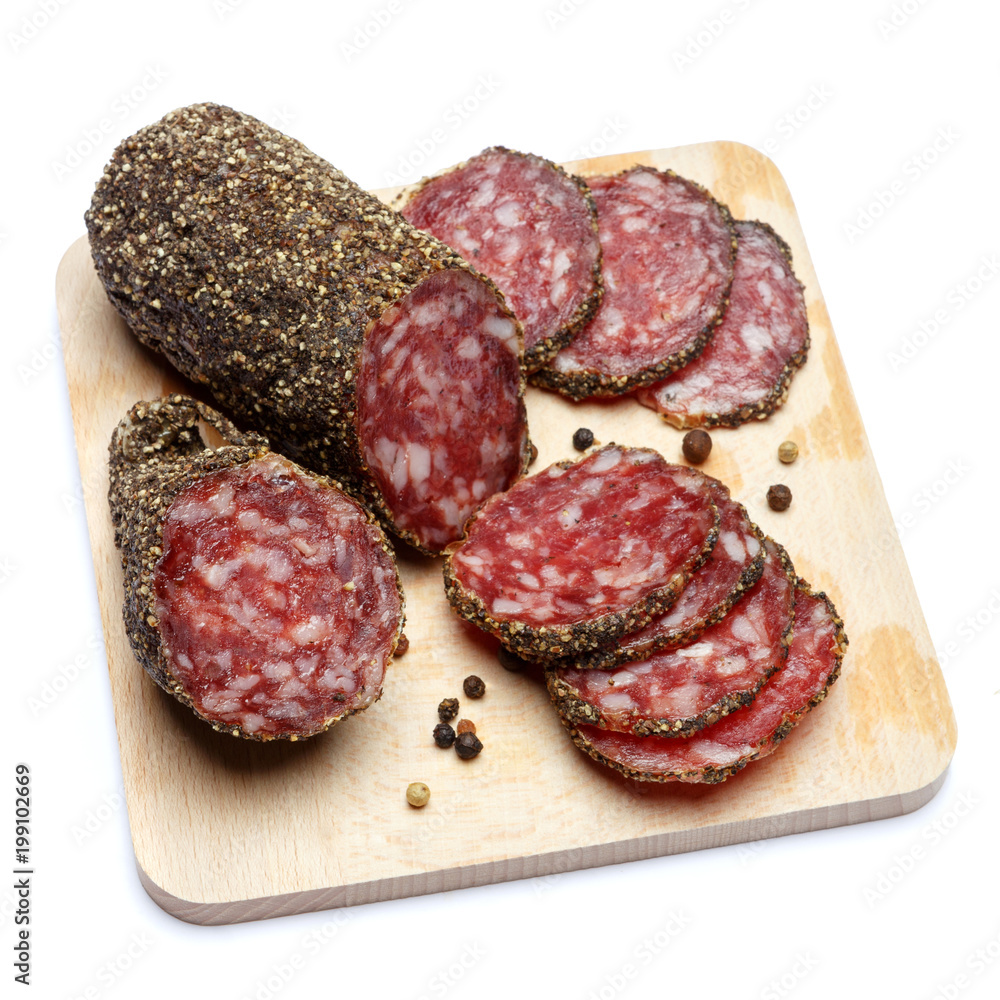 Dried organic salami sausage covered with pepper on wooden serving board