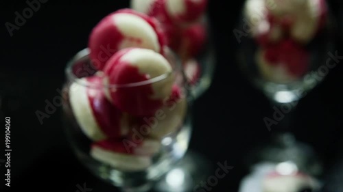 closeup confectionery hands put macaroons into glasses photo