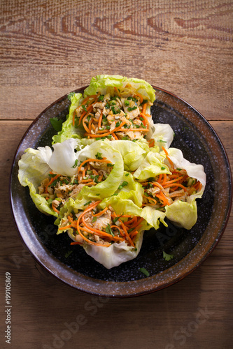 Stuffed iceberg lettuce cabbage leaves with chicken and vegetables. Wraps pockets of lettuce with chicken. overhead