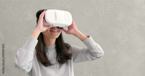 Woman playing with VR deivce photo