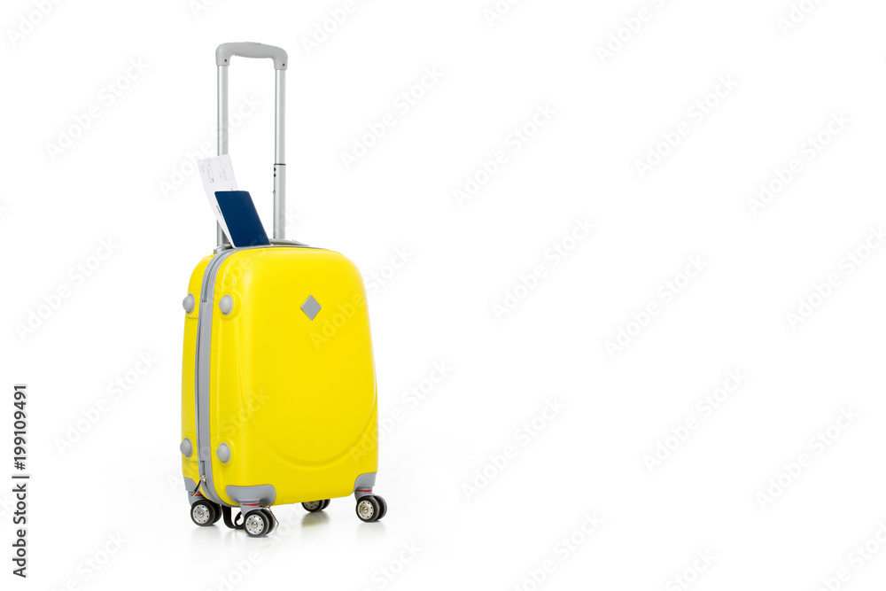 yellow suitcase with passport and ticket isolated on white yellow suitcase with passport and ticket isolated on white
