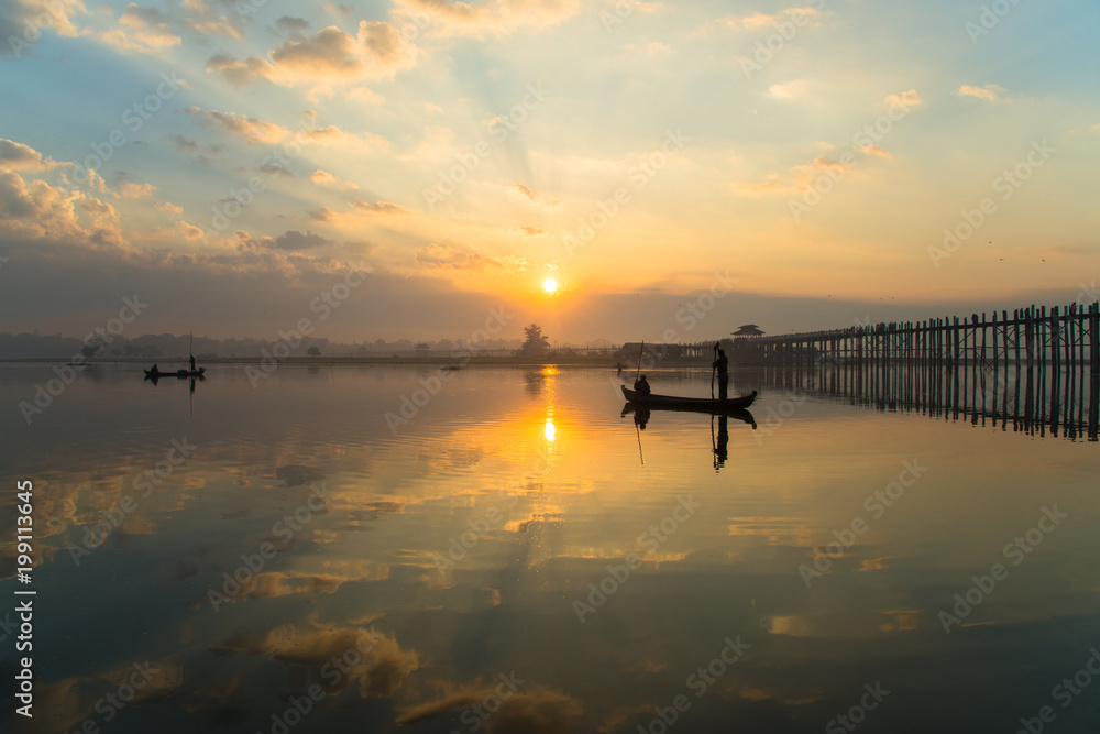 The beautiful sunrise over U Bein Bridge, Taungthaman Lake near Amarapura in Myanmar.