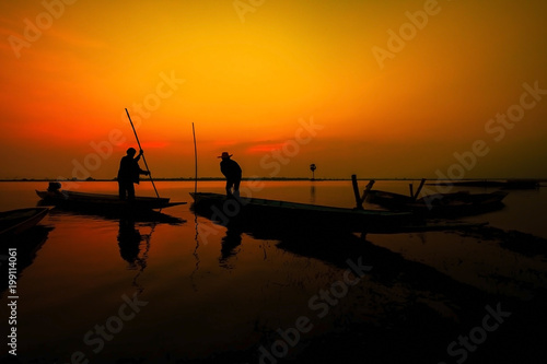 silhouette fisherman with beautiful sunset