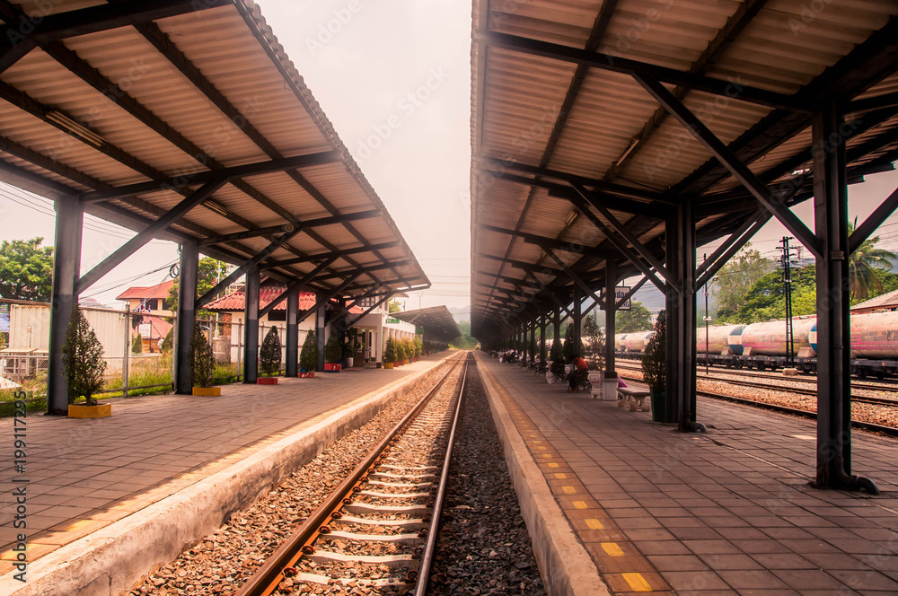 old straight railway and small stone at station.
