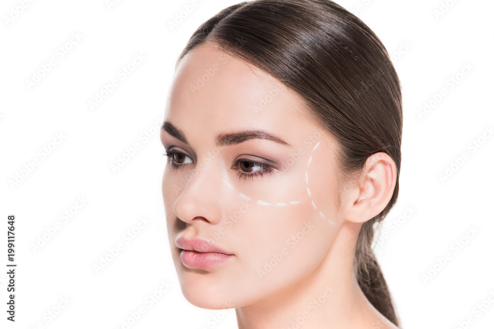 attractive young woman with dotted line drawn on face for plastic surgery isolated on white