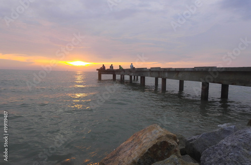 Wallpaper Mural loseup view peaceful beach with unidentified people during sunset. Selective focus and crop fragment. Torontodigital.ca