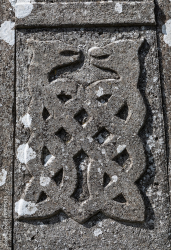 stone carved Celtic dragons design on old gravestone