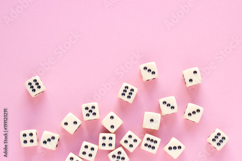 Gaming dice with copy space on pink background. Concept for games  game board  presentation  banners or web. Top view. Close-up.