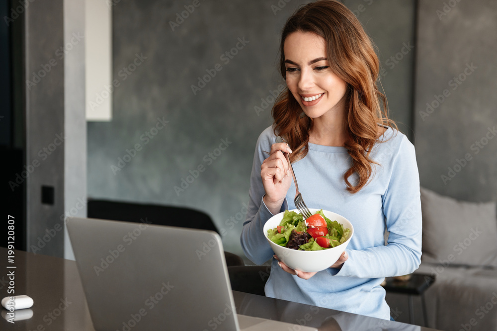 Portrait of a pretty young woman eating fresh salad Portrait of a pretty young woman eating fresh salad