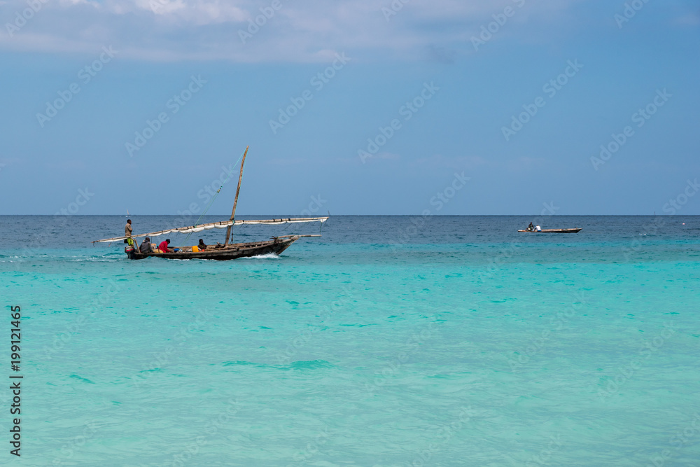 authentic African wooden fishing boat sails in the ocean authentic African wooden fishing boat sails in the ocean