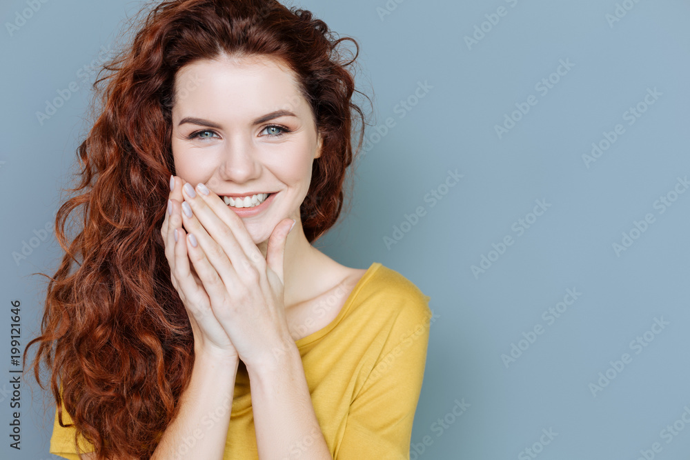 Sincere emotions. Portrait of a delighted joyful woman smiling and looking at you while expressing her emotions of happiness Sincere emotions. Portrait of a delighted joyful woman smiling and looking at you while expressing her emotions of happiness
