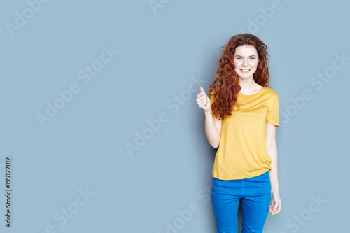 Positive emotions. Nice cheerful delighted woman smiling and expressing her positive emotions while feeling happy