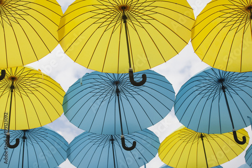 Colorful umbrellas flying into the air