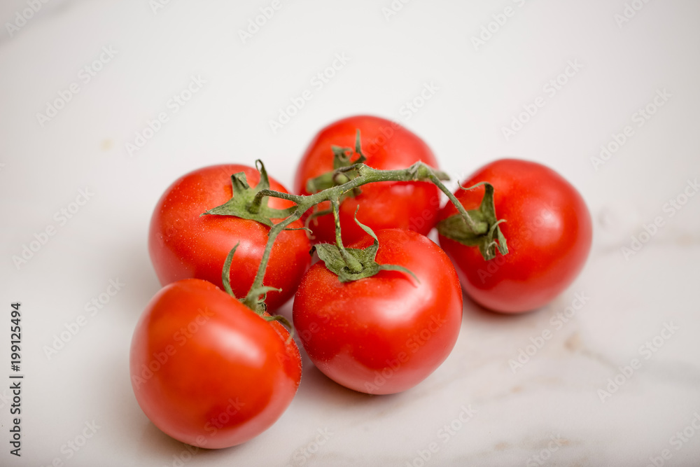 A bunch of isolated tomatoes on white background A bunch of isolated tomatoes on white background