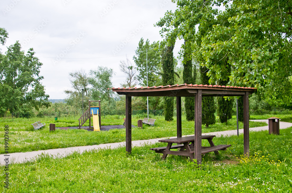 picnic area and children's games in the park amid the tall grass